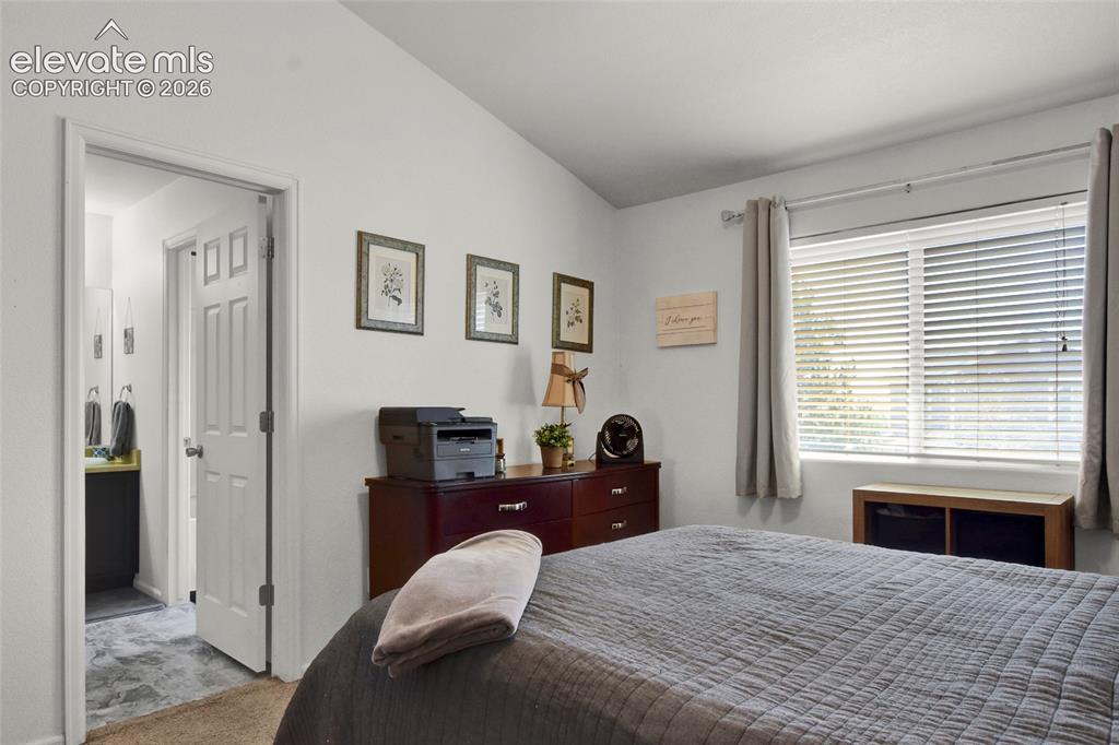 Image 10 of 22: Primary Bedroom with vaulted ceilings