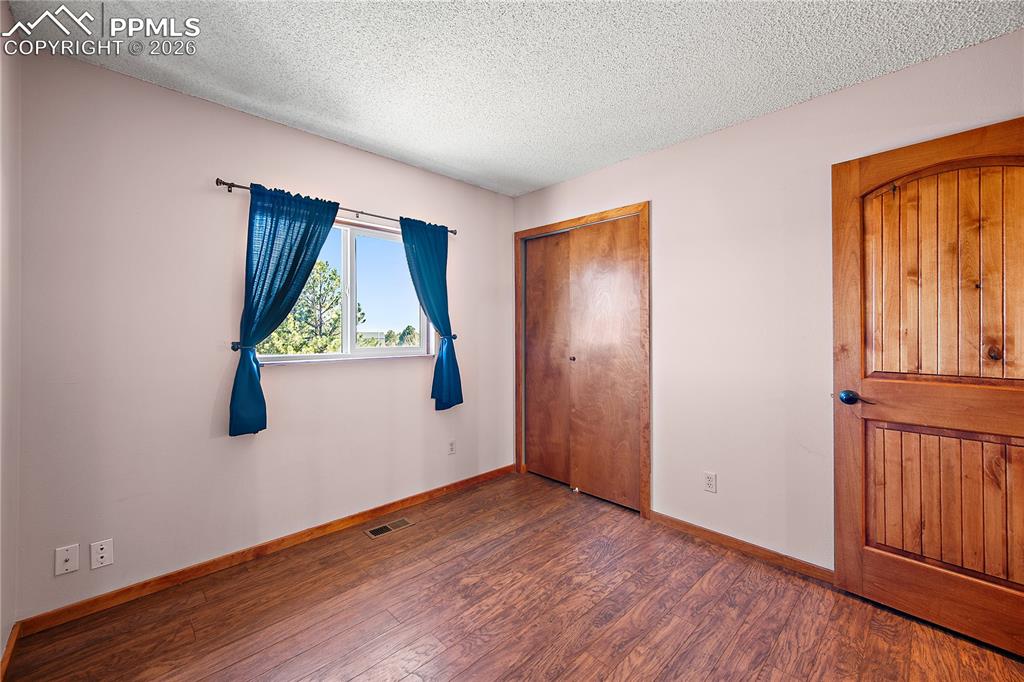 Image 19 of 40: Bedroom with laminate flooring and good sized flooring.