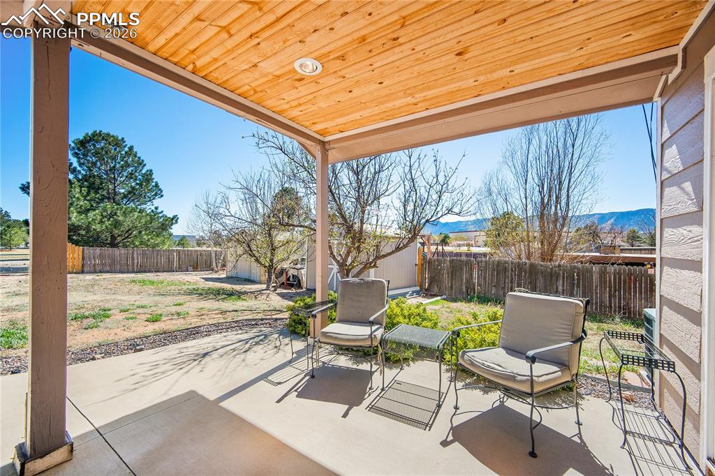 Image 33 of 40: Covered patio space off the dining/ entertaining space.