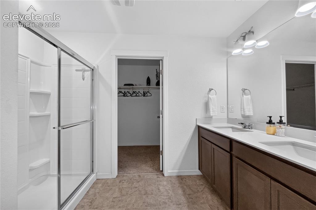Image 10 of 22: Contemporary bathroom featuring a glass-enclosed walk-in shower with built-