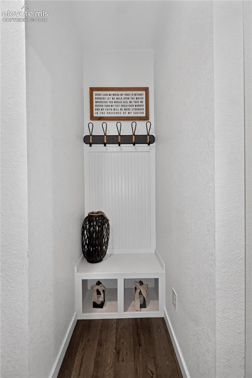 Image 20 of 22: Built-in entryway bench with beadboard backing, open storage cubbies, and o