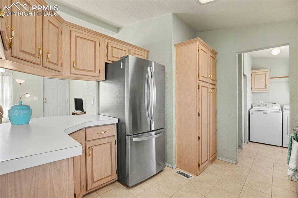 Image 10 of 27: The kitchen flows seamlessly into an open-concept layout, featuring an open