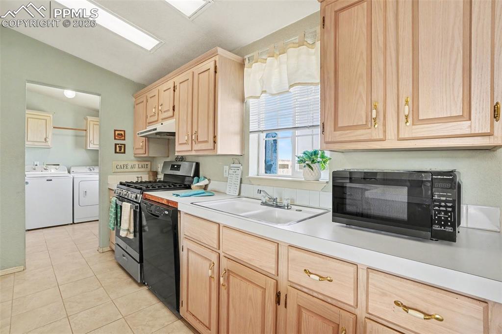 Image 11 of 27: Kitchen connected to a nearby laundry room for added convenience