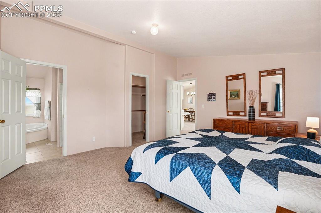 Image 13 of 27: Expansive primary bedroom featuring a walk-in closet and adjoining five-pie