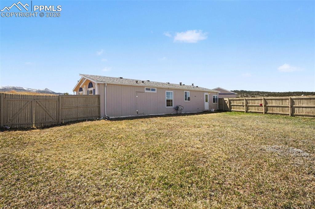 Image 21 of 27: The back of the home provides a comfortable outdoor extension