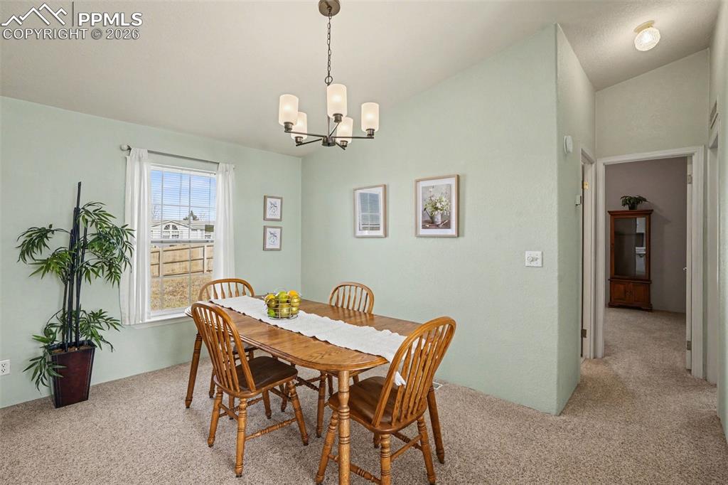 Image 8 of 27: The dining area is comfortably situated within the open floor plan, creatin