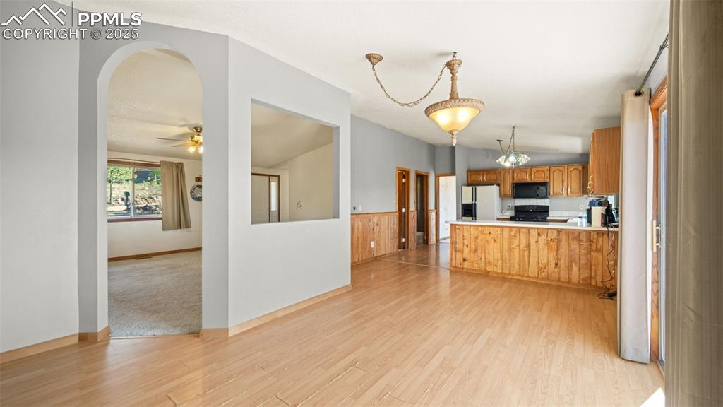 Image 11 of 36: Kitchen featuring light countertops, lofted ceiling, light wood-style floor