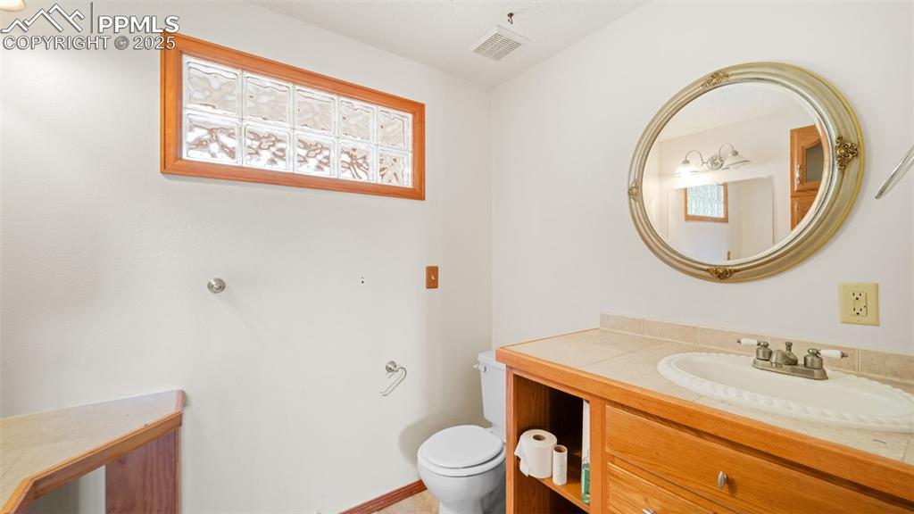 Image 14 of 36: Bathroom with vanity and toilet