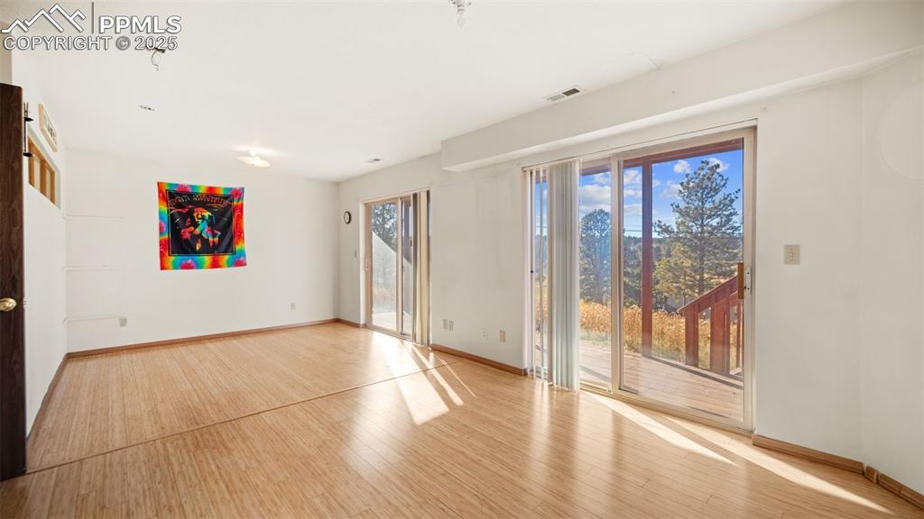 Image 19 of 36: Spare room featuring wood finished floors and baseboards