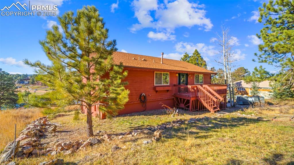Image 3 of 36: Back of property featuring a deck and stairs