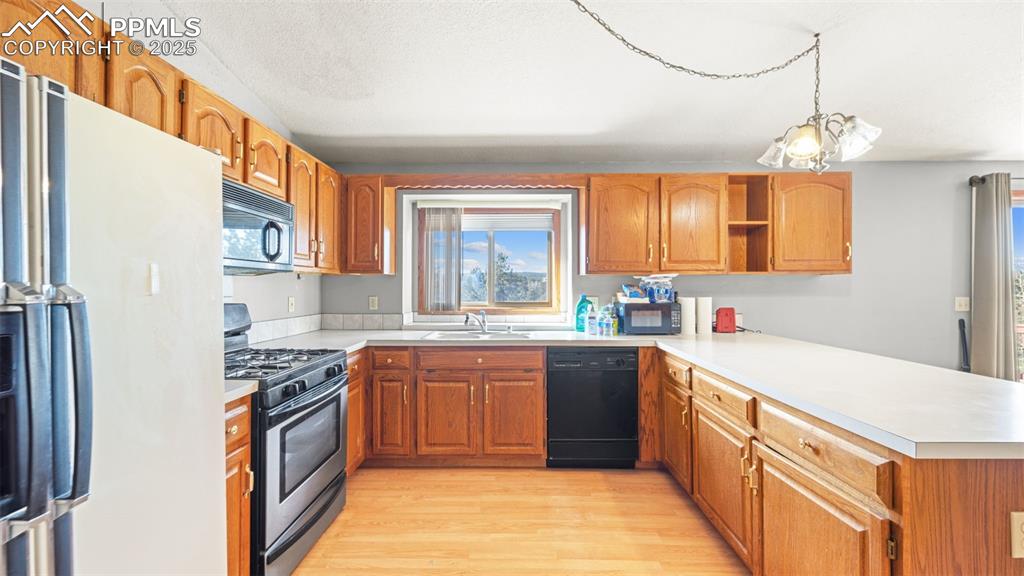 Image 9 of 36: Kitchen with vaulted ceiling, white refrigerator with ice dispenser, stainl
