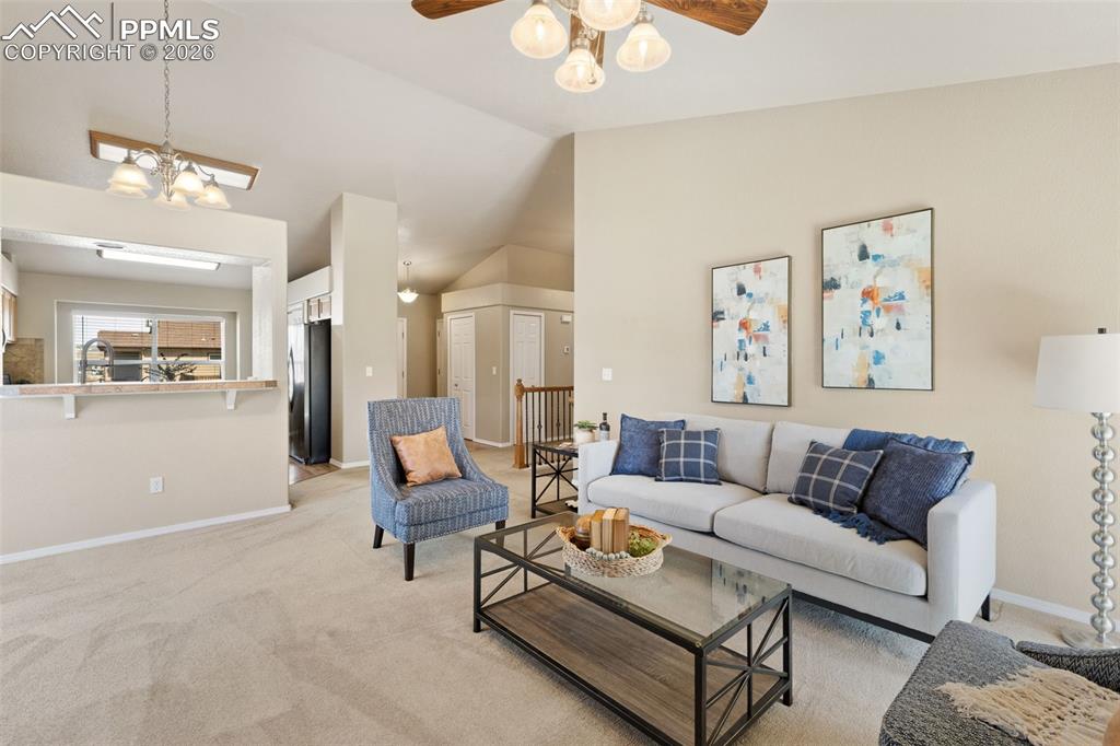Image 11 of 44: Living room with view into kitchen pass through.