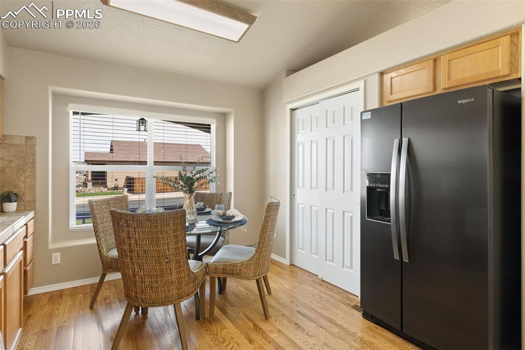 Image 17 of 44: Kitchen with view of pantry next to refrigerator.
