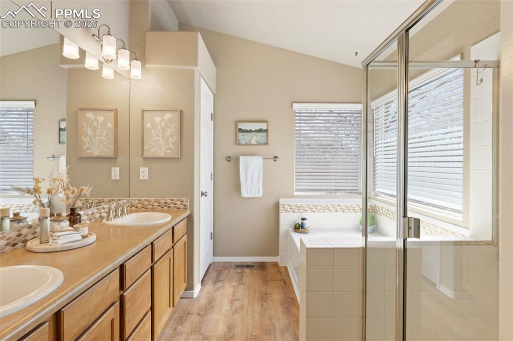 Image 21 of 44: Primary 5 piece bath with luxury vinyl plank floors.