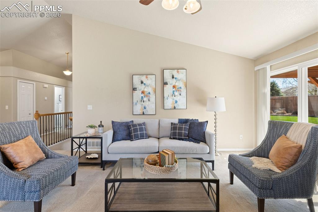 Image 8 of 44: Living room with vaulted ceiling.