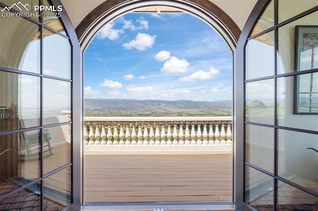 Image 18 of 36: Twin balconies with arched French doors overlooking mountain views to the W