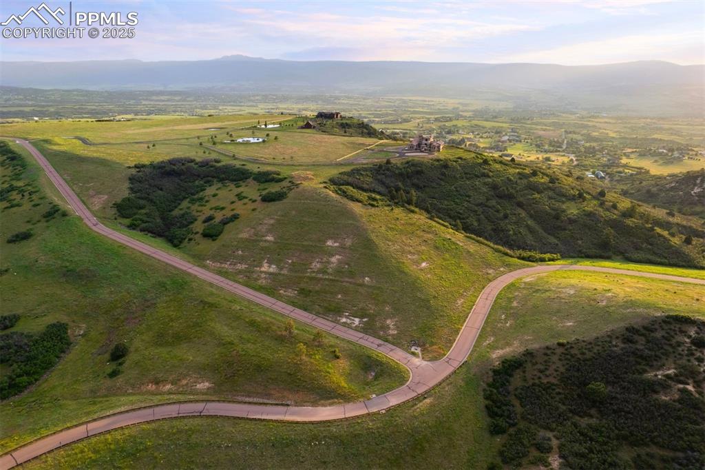 Image 36 of 36: A final wide-sweeping view of the gated community and winding roads leading