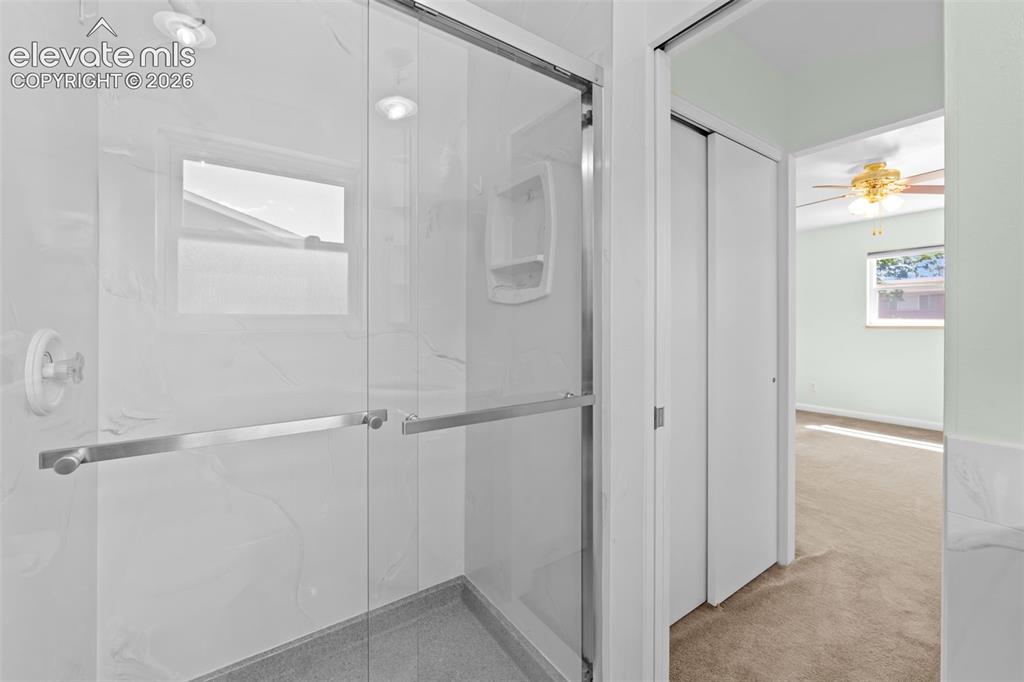 Image 20 of 34: Shower enclosure with clear glass doors and brushed nickel hardware