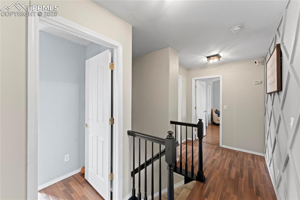 Image 12 of 37: Hallway featuring dark hardwood / wood-style flooring