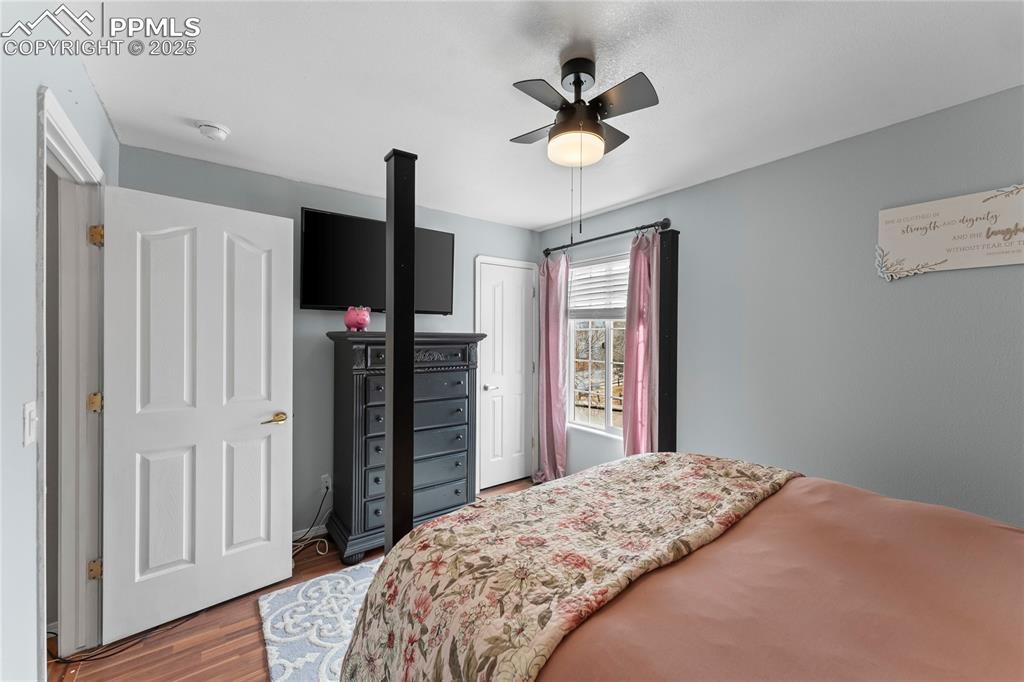 Image 18 of 37: Bedroom with hardwood / wood-style flooring, ceiling fan, and a closet