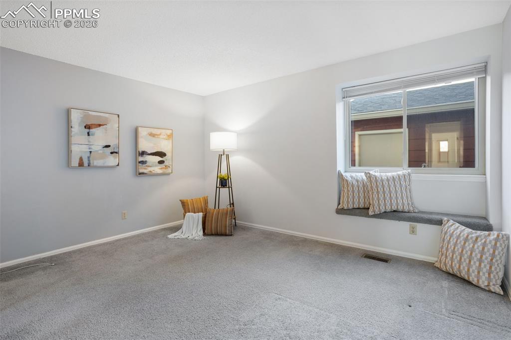 Image 21 of 31: Room with gorgeous natural light and carpet floors