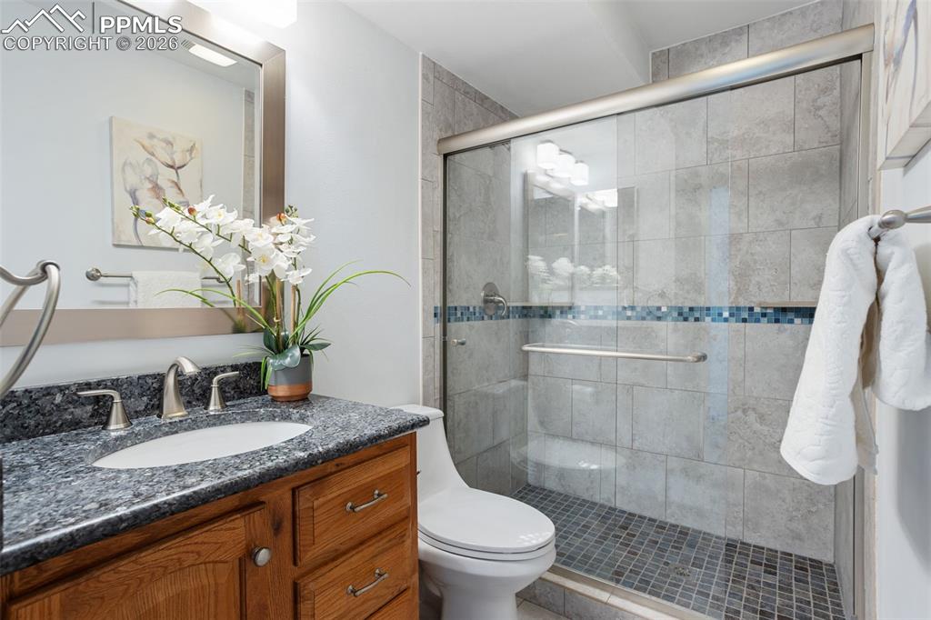 Image 23 of 31: Full bath with vanity and a shower stall