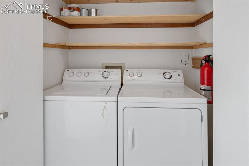 Image 24 of 31: Laundry room with washing machine and clothes dryer