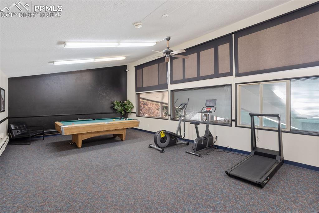 Image 28 of 31: COMMUNITY CLUBHOUSE: Multi-purpose room with worjout equipment, billiards,