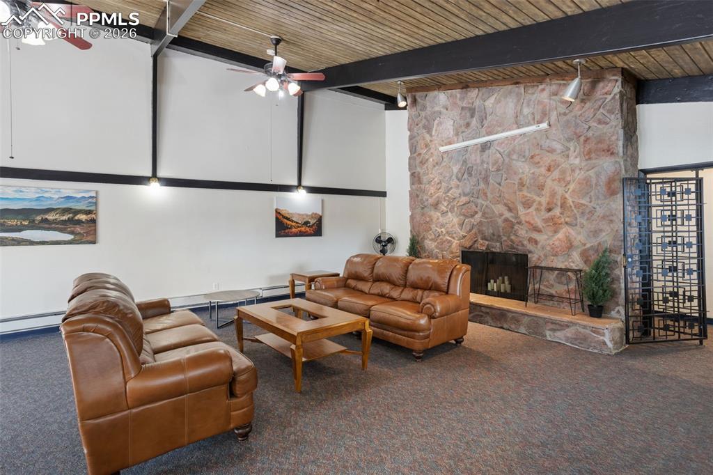 Image 30 of 31: COMMUNITY CLUBHOUSE: Carpeted living area featuring a towering ceiling, a f