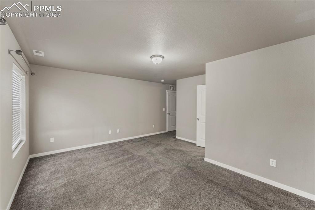 Image 19 of 29: Carpeted spare room with baseboards and a textured ceiling