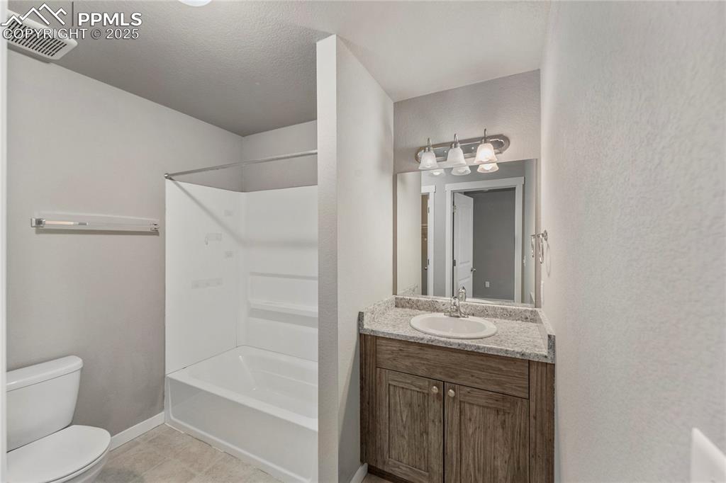 Image 20 of 29: Full bath with vanity, tub / shower combination, light tile patterned floor