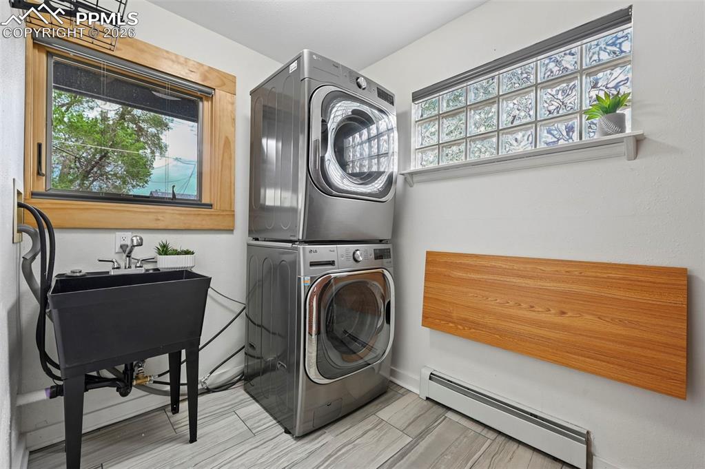 Image 14 of 40: main level laundry room with folding table