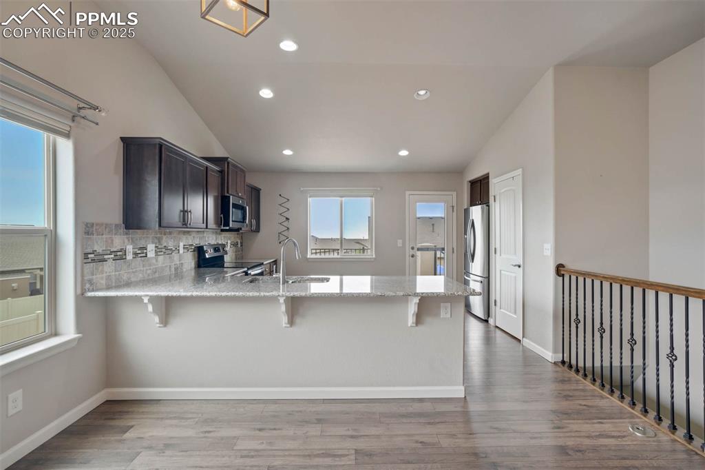 Image 16 of 45: Kitchen featuring a peninsula, appliances with stainless steel finishes, a 