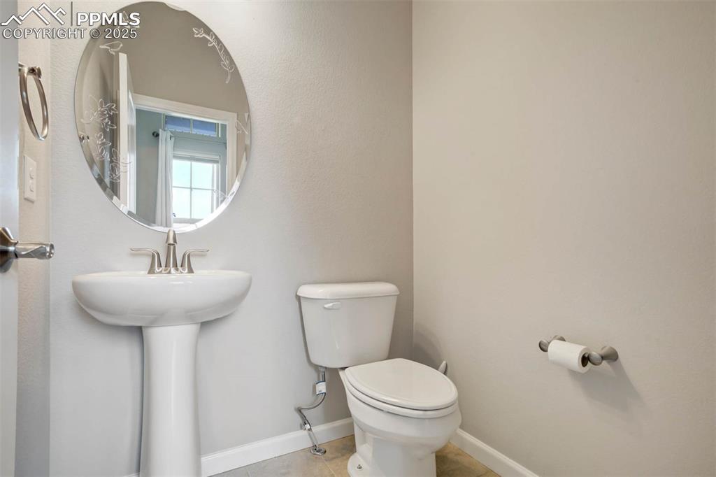 Image 17 of 45: Half bathroom featuring toilet and tile patterned flooring