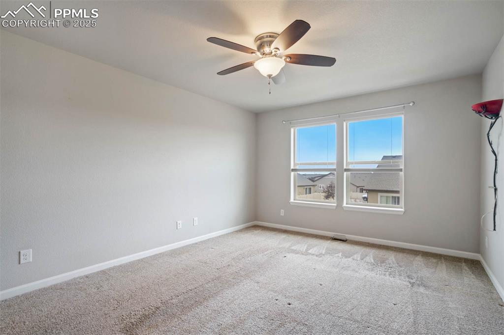 Image 20 of 45: Unfurnished room featuring light colored carpet and ceiling fan