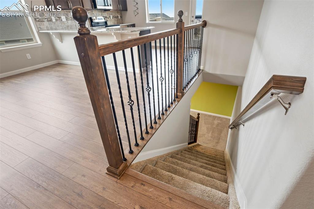 Image 26 of 45: Stairs with wood finished floors