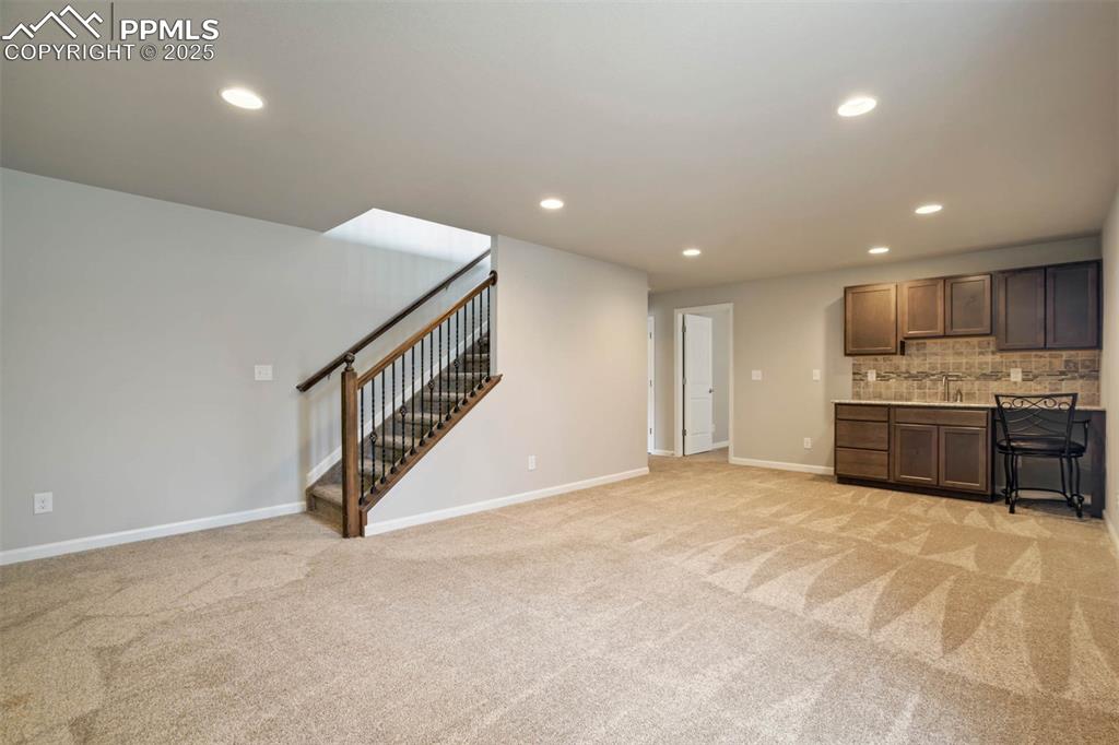 Image 27 of 45: Kitchen featuring recessed lighting, light colored carpet, backsplash, and 