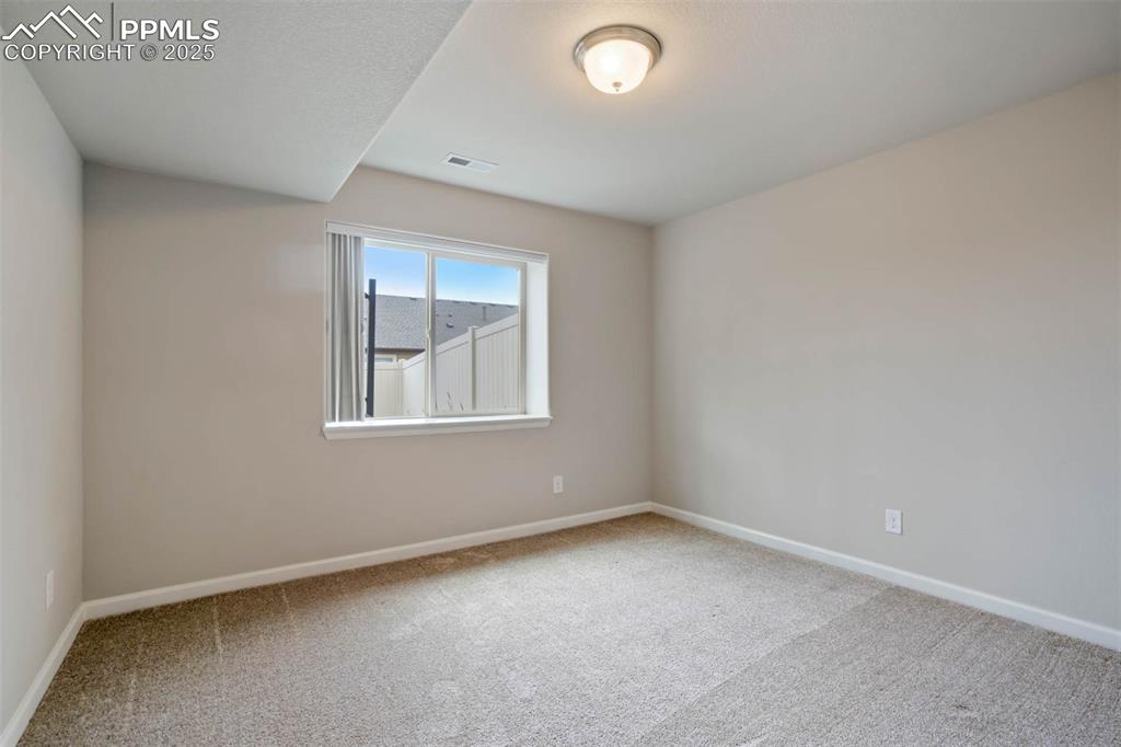 Image 35 of 45: Carpeted spare room with baseboards