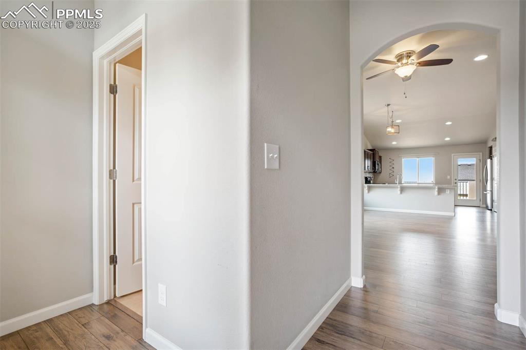 Image 6 of 45: Corridor featuring wood-type flooring, recessed lighting, and arched walkwa