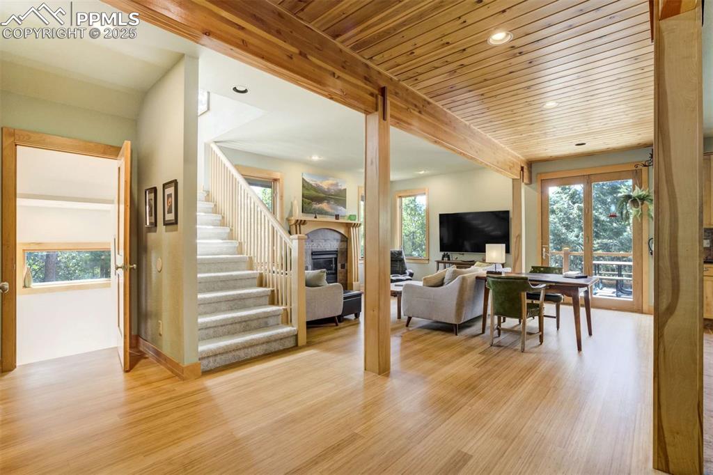 Image 10 of 50: Living room with recessed lighting, bamboo flooring, a fireplace, stairway,