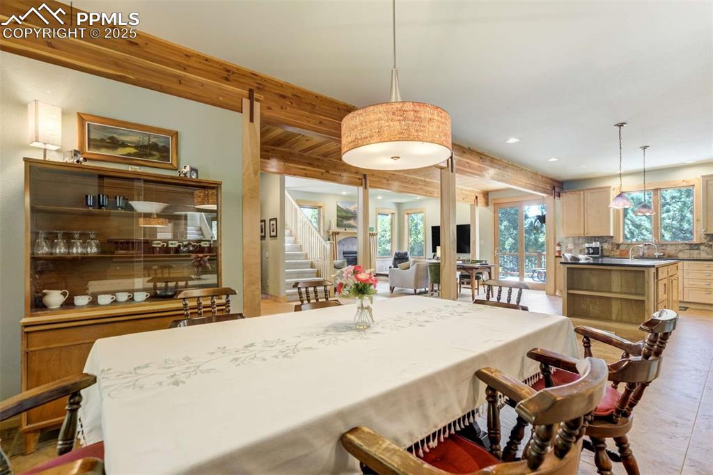 Image 15 of 50: Comfortable spacios dining room with a healthy amount of natural light.