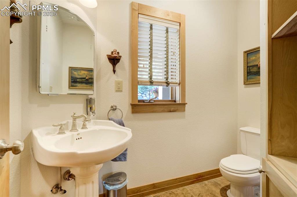 Image 21 of 50: Half guest bathroom with built-ins