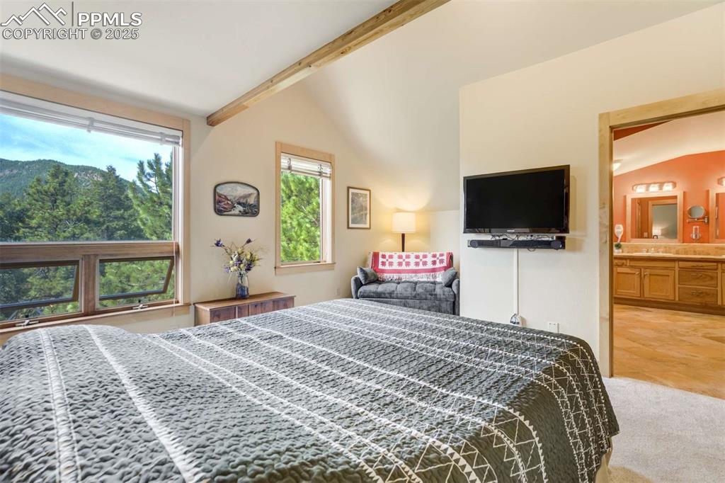 Image 22 of 50: Primary suite with attached 5-piece bath. Hear the creek below as you fall