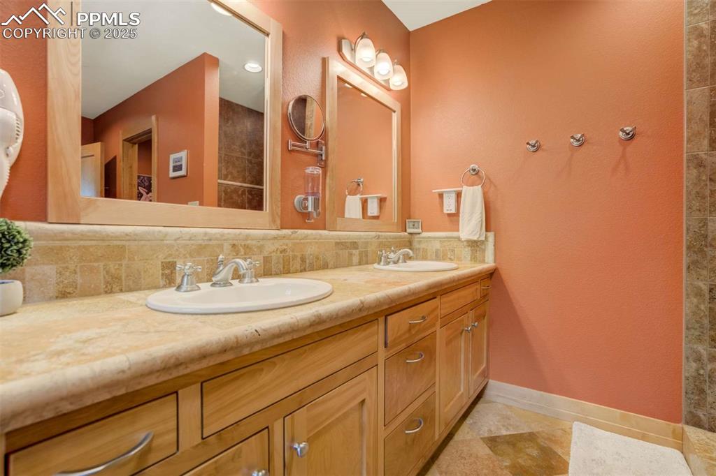 Image 26 of 50: Primary attached bathroom with double vanity