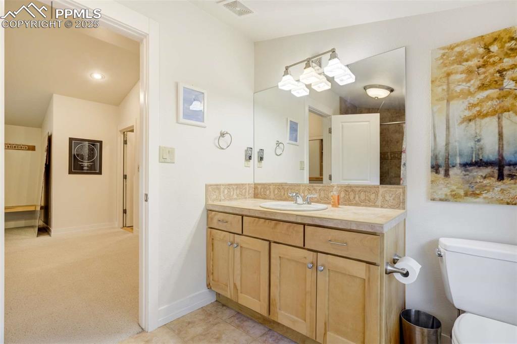 Image 32 of 50: 3rd guest bathroom featuring vanity and tile patterned floors