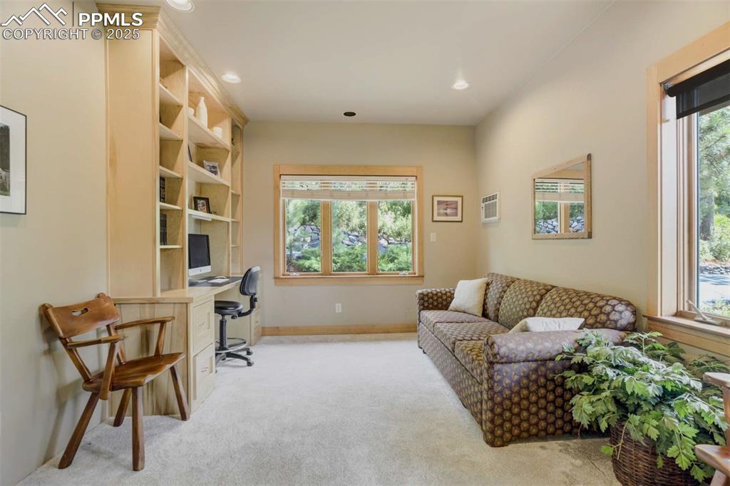 Image 34 of 50: Office area with light colored carpet and recessed lighting