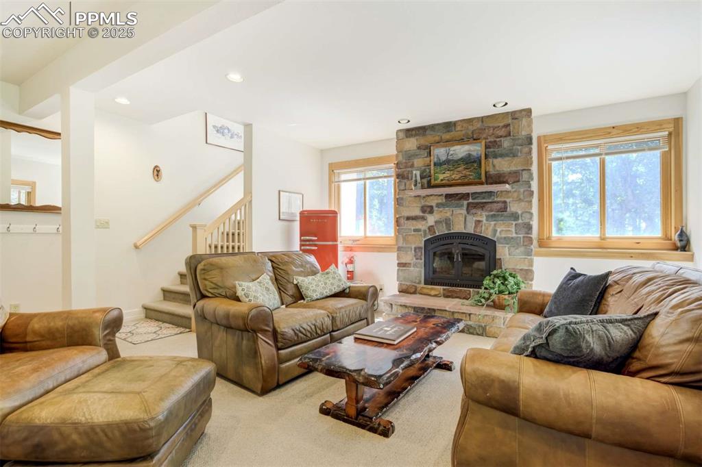 Image 35 of 50: Living room featuring stairs, carpet flooring, recessed lighting, and a fir