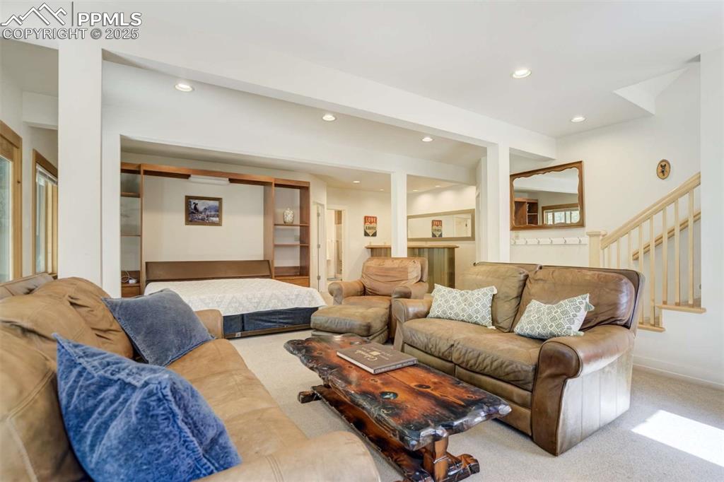 Image 36 of 50: Carpeted living area featuring recessed lighting.