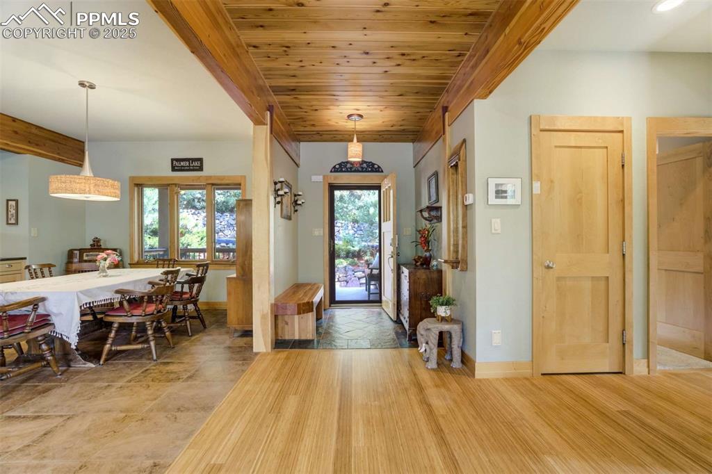 Image 8 of 50: Entrance foyer featuring a wooden ceiling with exposed beams and bamboo flo