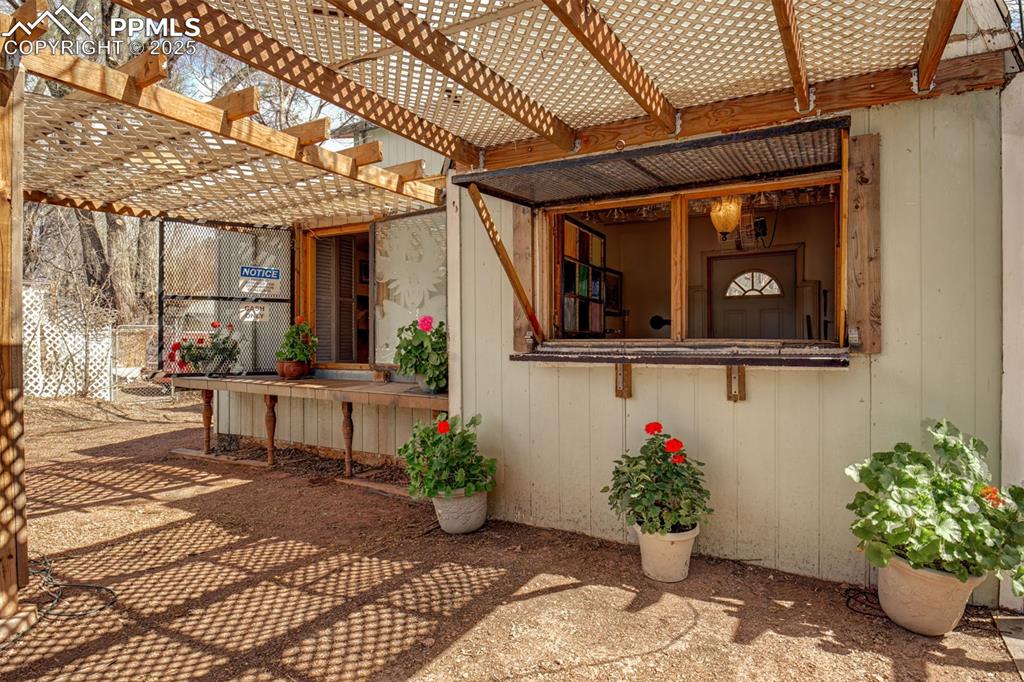 Image 19 of 45: Secret Garden: Bar Hut - Dual windows for serving